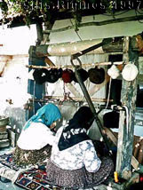 Photograph of women weaving